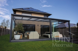 Moderne Gumax® Serre aanbouw in mat antraciet van 7,06 x 4 meter met opaal polycarbonaat dakplaten inclusief Gumax LED verlichting, glazen schuifwanden en Glazen spie